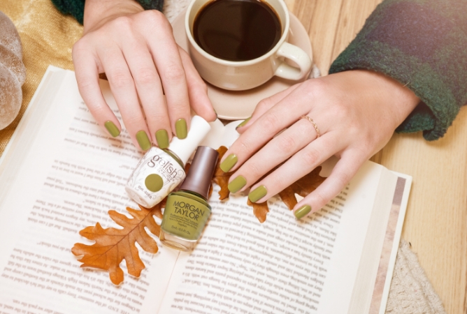 Cozy picture of a Gelish and Morgan Taylor bottle arrangement next to coffee