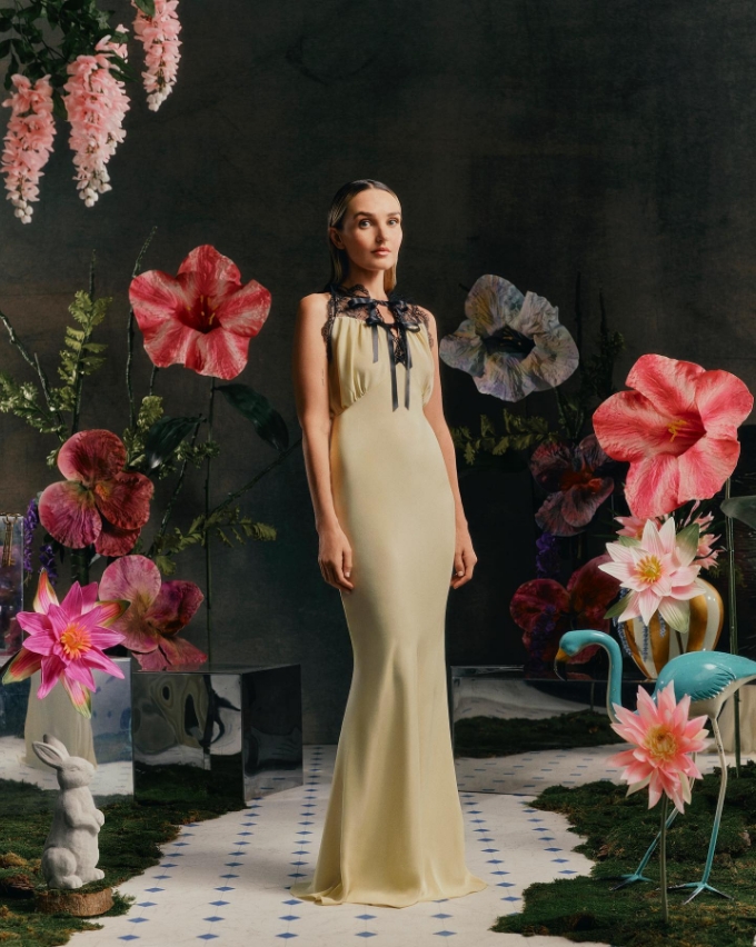 beige dress lady model with flower backdrop
